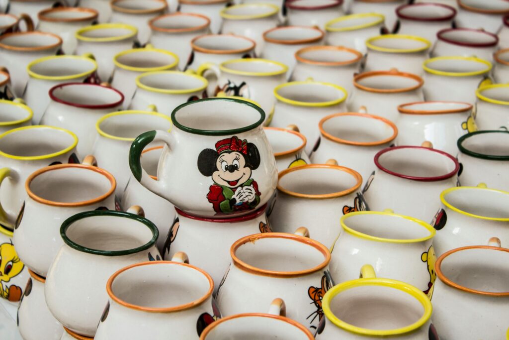 pexels-photo-34534478-34534478 A collection of stacked ceramic mugs with cartoon characters in Kütahya, Türkiye.